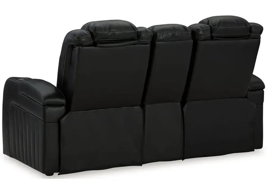 Caveman Den - Midnight - Power Reclining Loveseat With Console/ Adj Hdrst