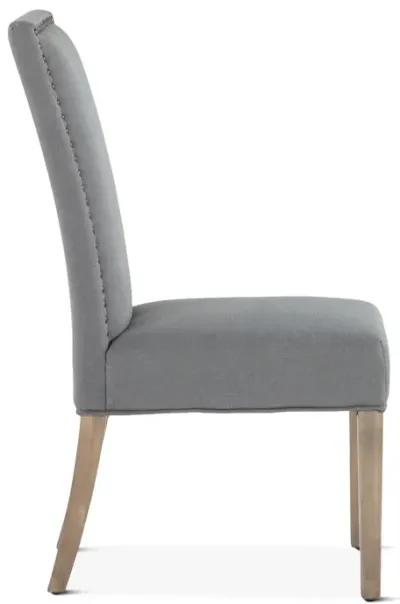 Home Trends Design Warm Gray Upholstered Dining Chair with Brass Nailhead Accents & Natural Wood Legs