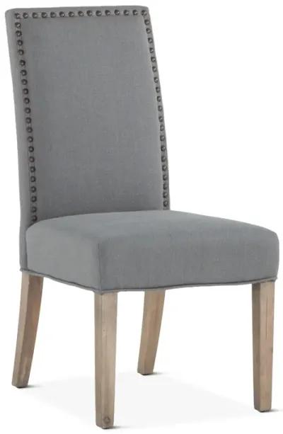 Home Trends Design Warm Gray Upholstered Dining Chair with Brass Nailhead Accents & Natural Wood Legs