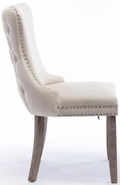 2 Beige Wingback Dining Chairs with Nailhead Trim & Wood Legs