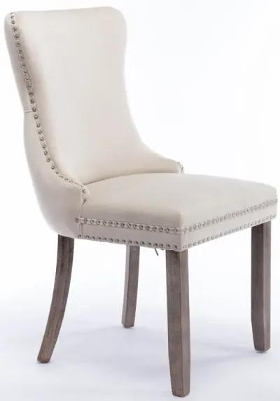 2 Beige Wingback Dining Chairs with Nailhead Trim & Wood Legs