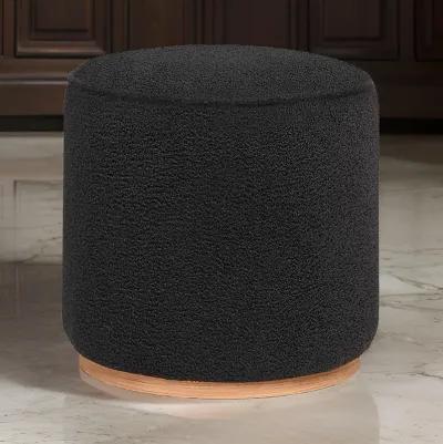 Zia 19 Inch Ottoman, Black Faux Sheepskin Upholstery, Round Platform Base - Benzara